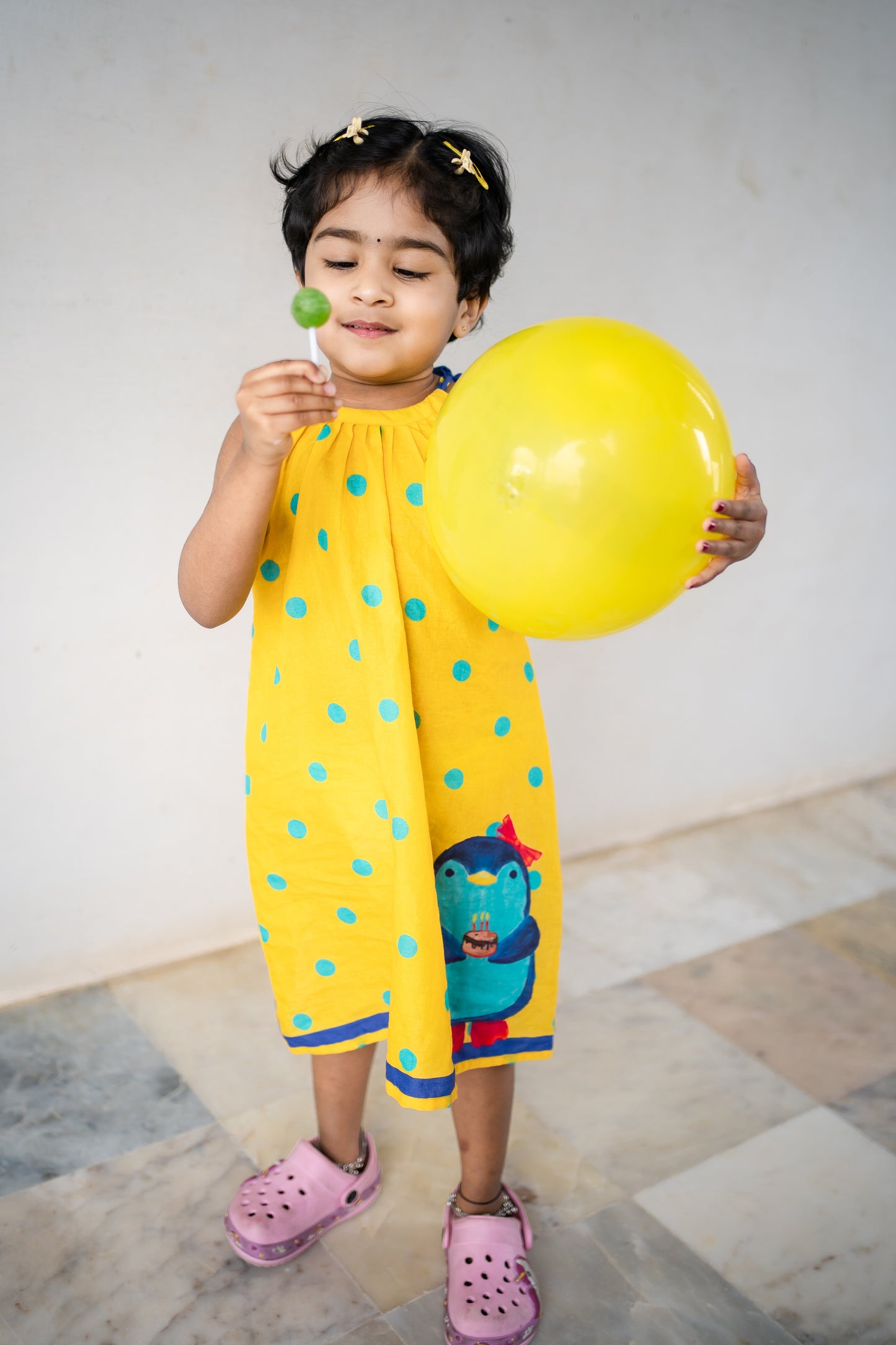 Bhavika Devarapalli Cotton frock, Floral print, Designer cotton frock, birthday theme, kids printed frocks, Best designer kids frock, top Indian Designer kids collection, Best Designer collection, yellow polki dots printed frock, penguin dress, doodles frock.